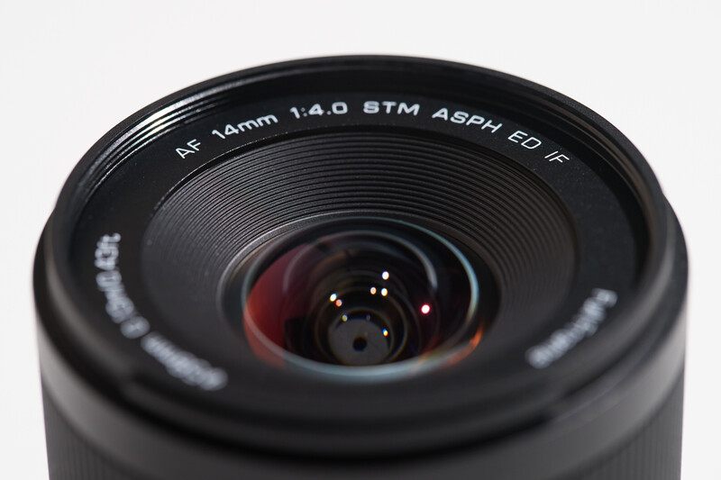 Rokinon 14mm f/1.4 wide-angle lens with visible aperture blades and lens markings