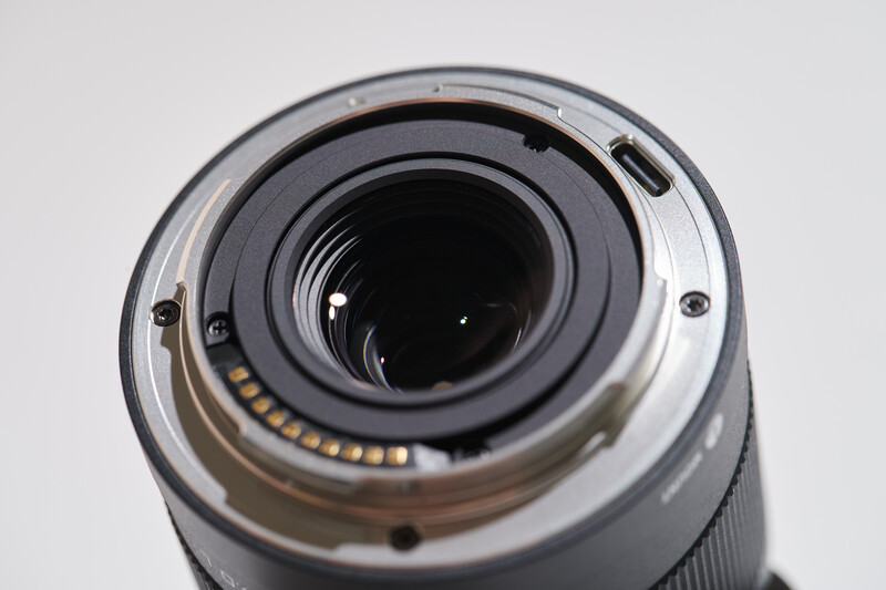 Rear view of camera lens showing internal glass elements and electronic contacts