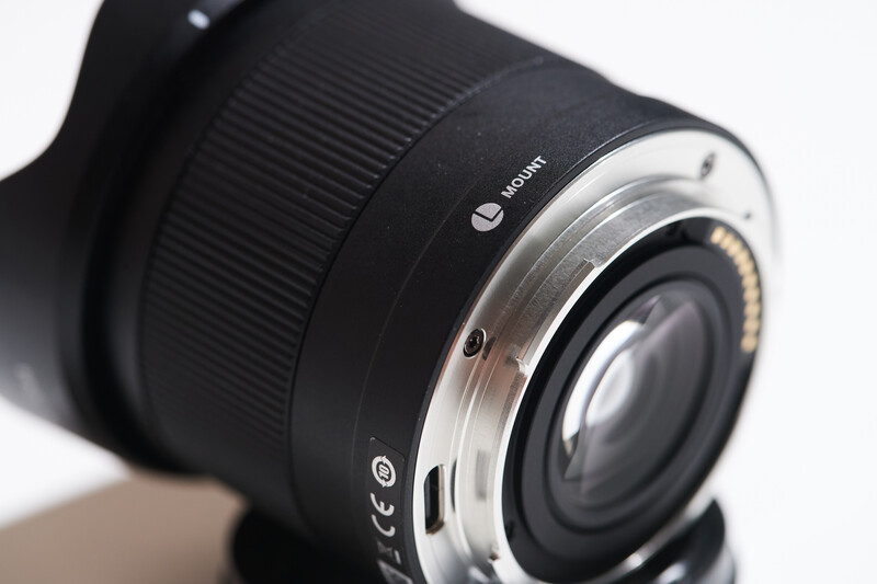 Close-up of a wide-angle camera lens with ribbed focus ring and metal bayonet mount