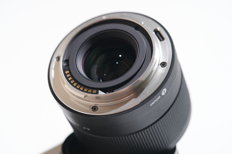 Rear view of a camera lens with gold-rimmed contacts and metal bayonet mount