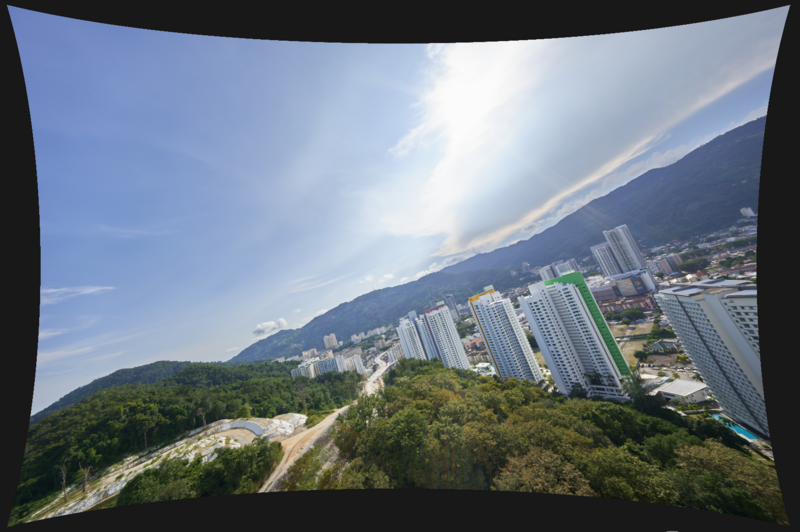Aerial view of a residential valley with high-rise apartment buildings nestled between forested mountains