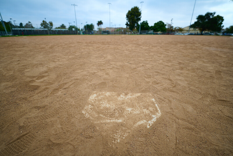Heart shape drawn in white chalk on sandy baseball field