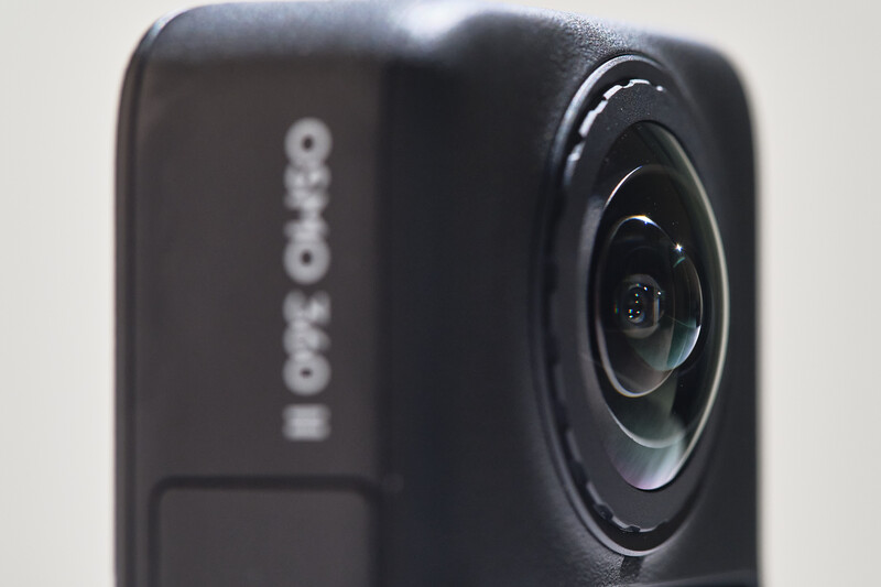 Close-up of a black action camera with wide-angle lens and branding visible on the side
