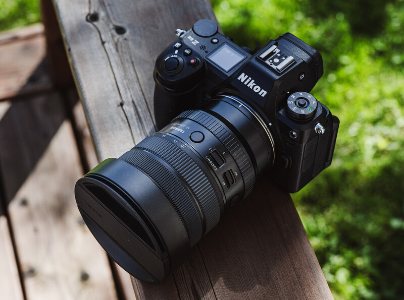 Nikon mirrorless camera with attached zoom lens on wooden surface