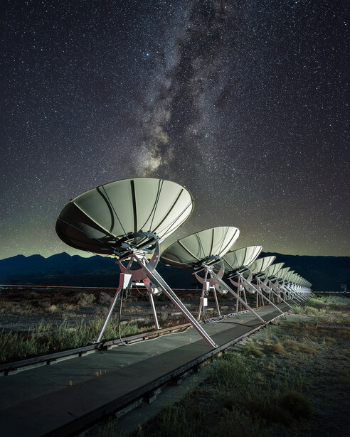 A seemingly infinite row of radio telescopes underneath the Milky Way, with the mighty Sierra Nevada Mountain range as the backdrop. It doesn't get much better than this.