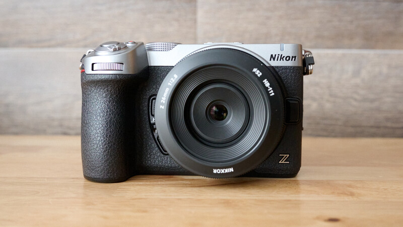 Nikon Z mirrorless camera with silver top plate and black body on wooden surface