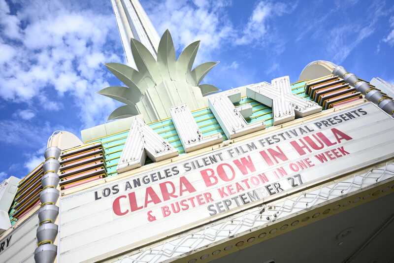 Los Angeles theater marquee displaying Silent Film Festival and Buster Keaton event information under blue sky