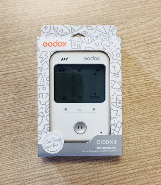 Godox C100 Kit lighting control device in retail packaging on wooden surface