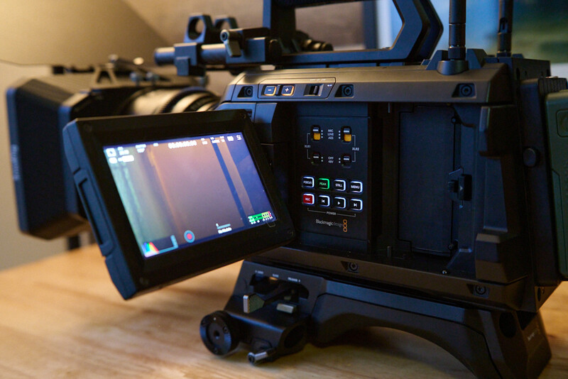 Professional video camera with articulating LCD monitor displaying live footage