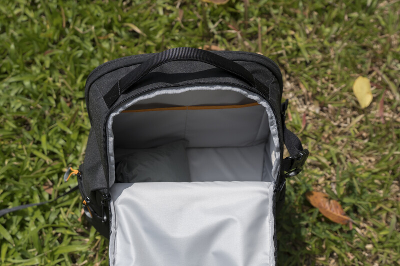 Open baby stroller with white fabric interior displayed on grass