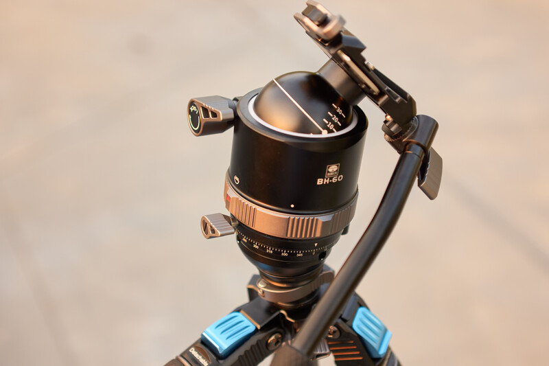 Sirui ball head with fluid drag system mounted on blue tripod legs