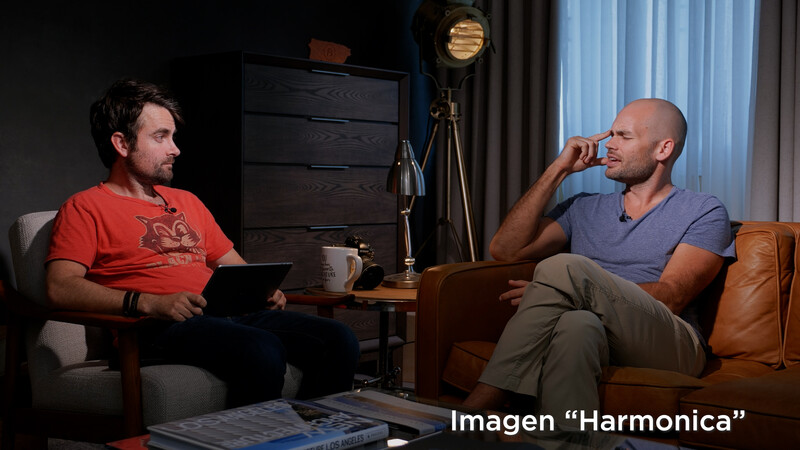 Two men in casual clothing seated on leather furniture during an interview or podcast recording session