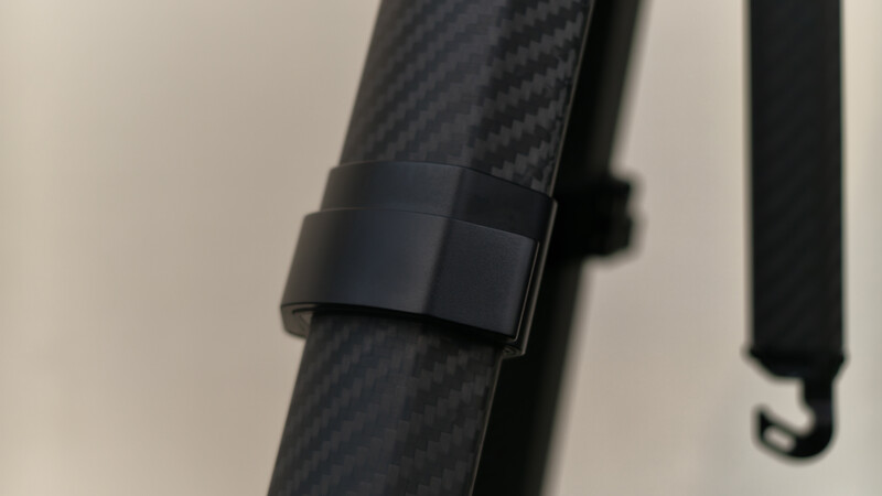 Close-up of black carbon fiber strap with rectangular black buckle or attachment point