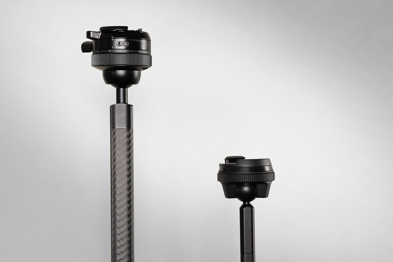 Two tripod ball heads mounted on carbon fiber poles of different heights against a neutral background