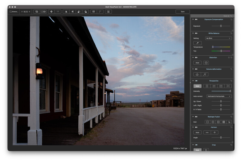 Screenshot of DxO ViewPoint editing a dusk photo of an old wooden frontier-style building with a glowing porch lantern