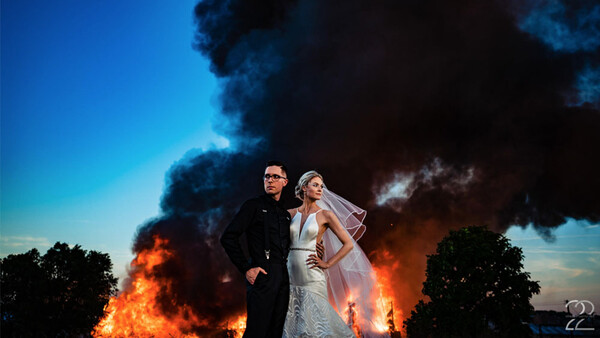 Photographer Shoots Bride and Groom's Wedding Pictures With a Burning Building as a Backdrop