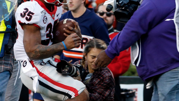 Kneeling Photographer Knocked Unconscious After Sideline Collision at Football Game