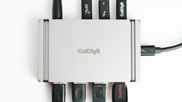 CalDigit USB hub with multiple cables connected to its ports, displaying cable management setup.