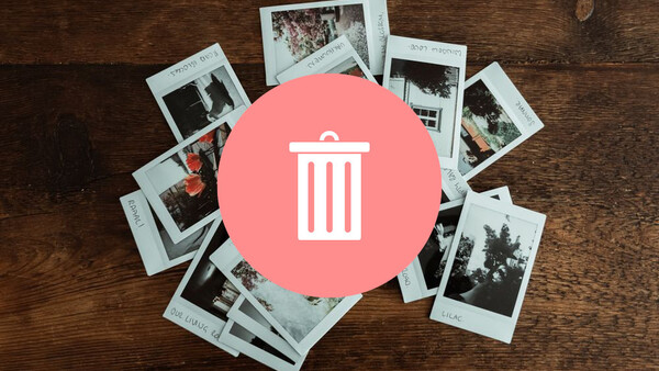 Trash can icon overlaid on scattered instant film photographs on a wooden surface.