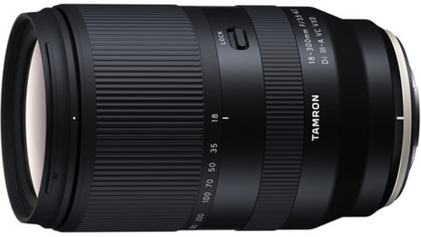 Tamron 18-300mm zoom lens with black barrel and ribbed focus ring against white background.