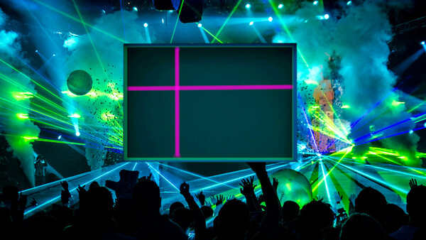 Large stage screen with magenta cross pattern during concert with silhouetted crowd and vibrant cyan and green laser lighting.