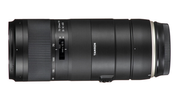 Tamron telephoto zoom lens with extended barrel and focus ring against white background.