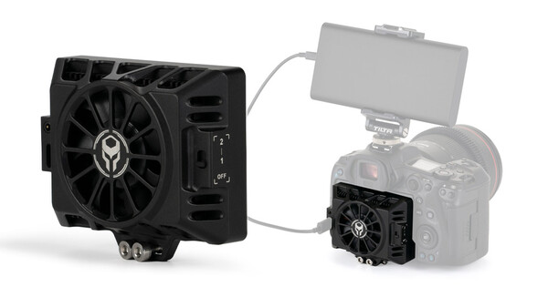 Two black cooling fan units connected by a cable, showing a larger external fan and a smaller on-camera mounted fan setup.