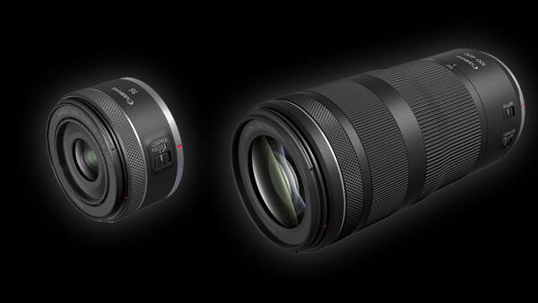 Two black camera lenses displayed against a dark background, showing a compact prime lens on the left and a longer telephoto zoom lens on the right.