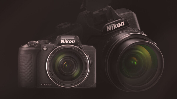 Two Nikon COOLPIX cameras displayed side-by-side against a dark background with studio lighting.