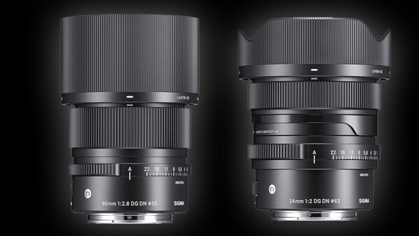Two telephoto camera lenses with vertical ribbed barrels displayed side-by-side against a dark background.