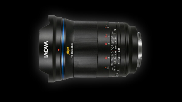 LAOWA wide-angle lens with blue ring and focus ring against dark background.