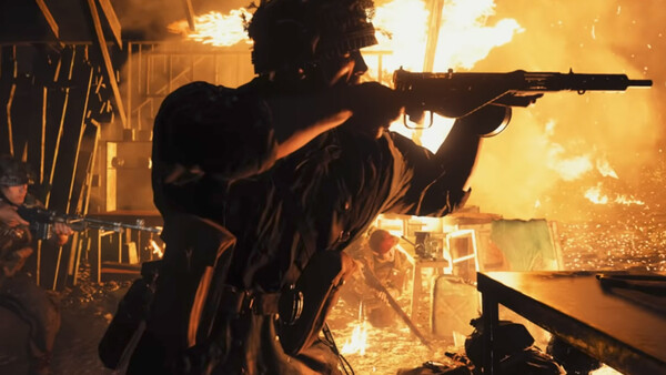 Silhouetted figure aiming rifle with dramatic golden fire and sparks illuminating the background.