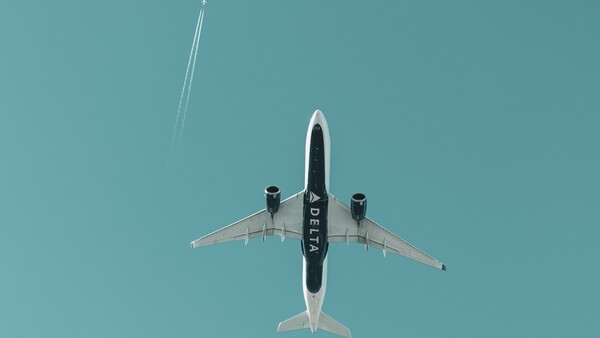 Aircraft shot from directly below against clear blue sky, showing symmetrical top-down composition.