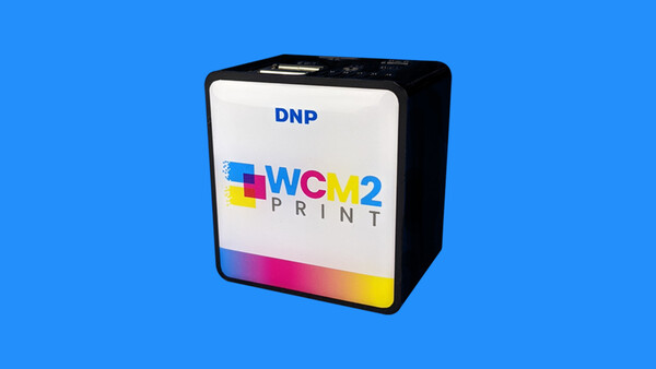 DNP WCM2 Print media cartridge box with colorful gradient design on blue background.