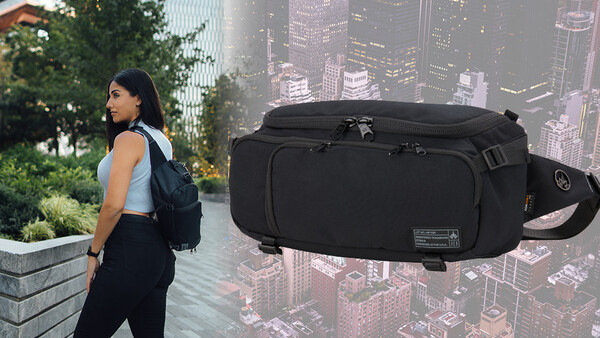 Woman wearing black travel backpack and waist bag against urban cityscape backdrop.