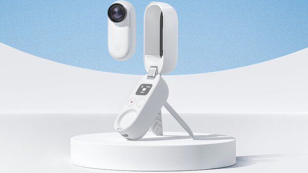 Product photography showing a compact white camera device mounted on a tripod stand against a minimalist blue and white background.