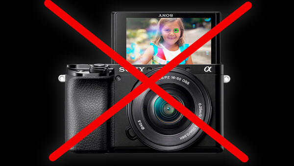 Graphic illustration of a mirrorless camera with red X marks overlaid, indicating prohibition or rejection.