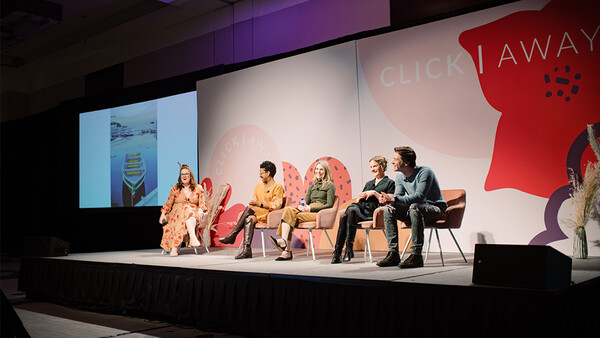 Five panelists seated on stage during a photography or creative industry conference discussion panel.