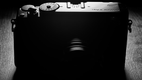 Overhead view of a rangefinder camera shot in high-contrast black and white.
