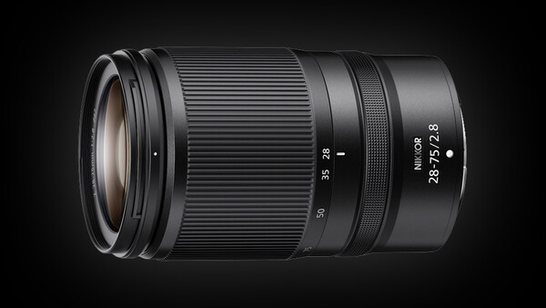 Nikon Z-mount telephoto zoom lens with 28-75mm focal length and f/2.8 maximum aperture against dark background.