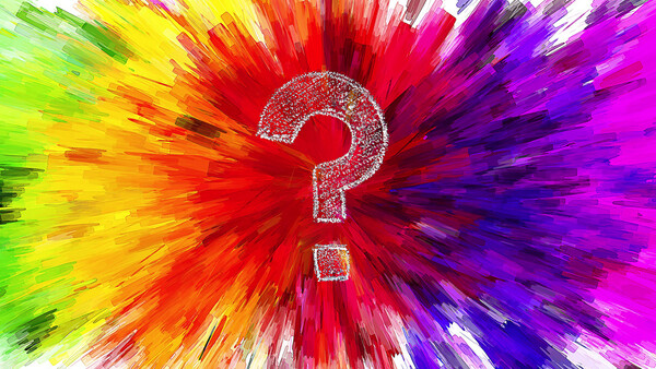 A white question mark centered in a radial burst of vibrant rainbow colors radiating outward.
