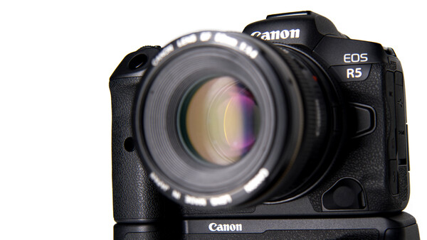 Canon EOS R5 mirrorless camera with standard prime lens mounted, shown from front-facing angle against white background.