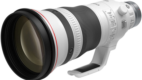 White telephoto lens with red accent ring and control rings, shown against white background.