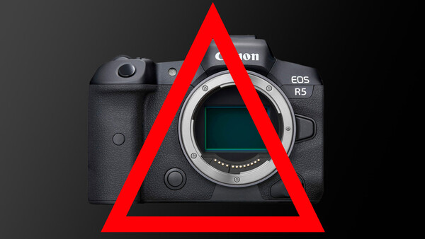 Canon EOS R5 mirrorless camera body with red warning triangle overlaid on front.