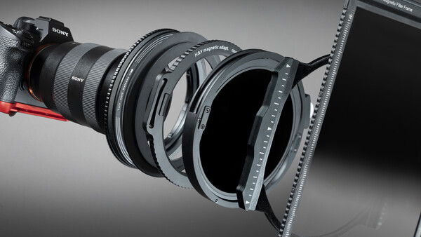 Sony camera lens with matte box and filter holder attachment system displayed in studio lighting.