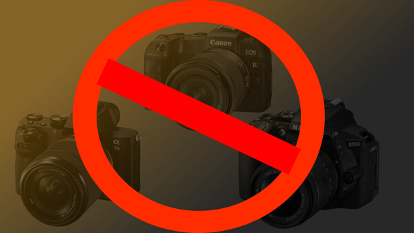 Illustration of three professional cameras with a red prohibition symbol overlaid across them.