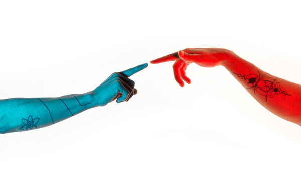 Two painted arms reaching toward each other against a white background, one blue with atomic symbols and one red with crackle texture.