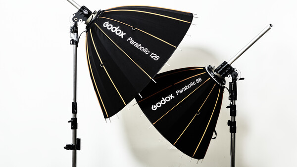 Two Godox Parabolic softboxes mounted on light stands against a white background.