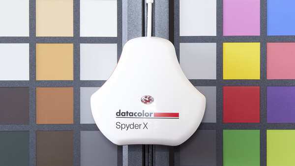 DataColor Spyder X color checker device positioned on a color reference chart.