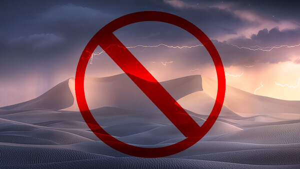 Large red prohibition symbol overlaid on a desert landscape with mountains and dramatic stormy sky.